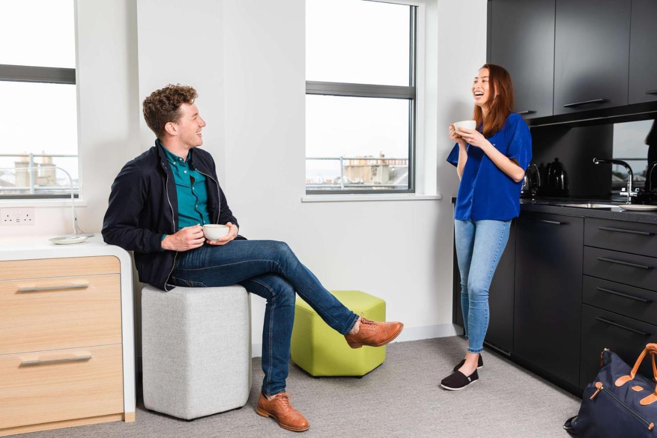 Yotel Edinburgh Exterior photo Two students chatting in a kitchen